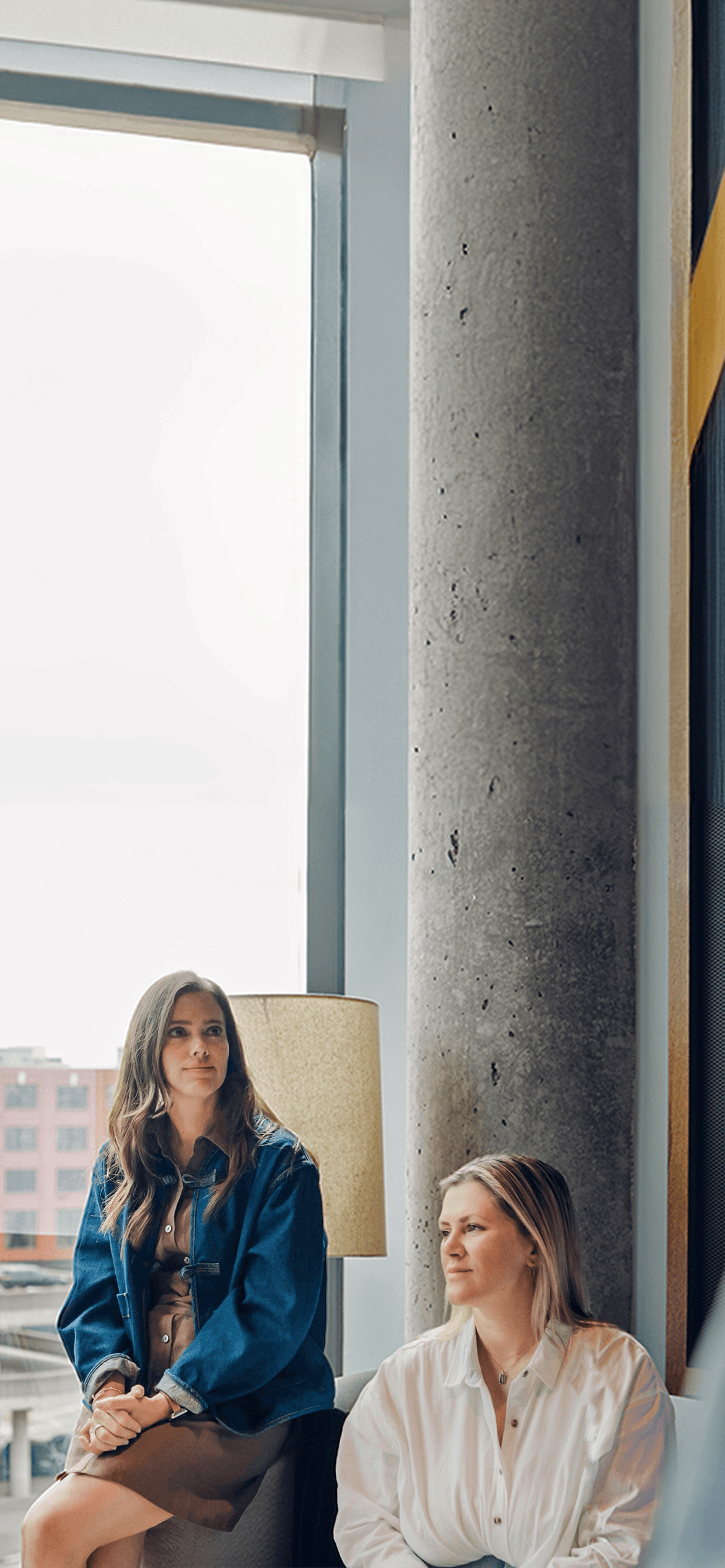 Alli and Jessie sitting by the window at the Robyn office