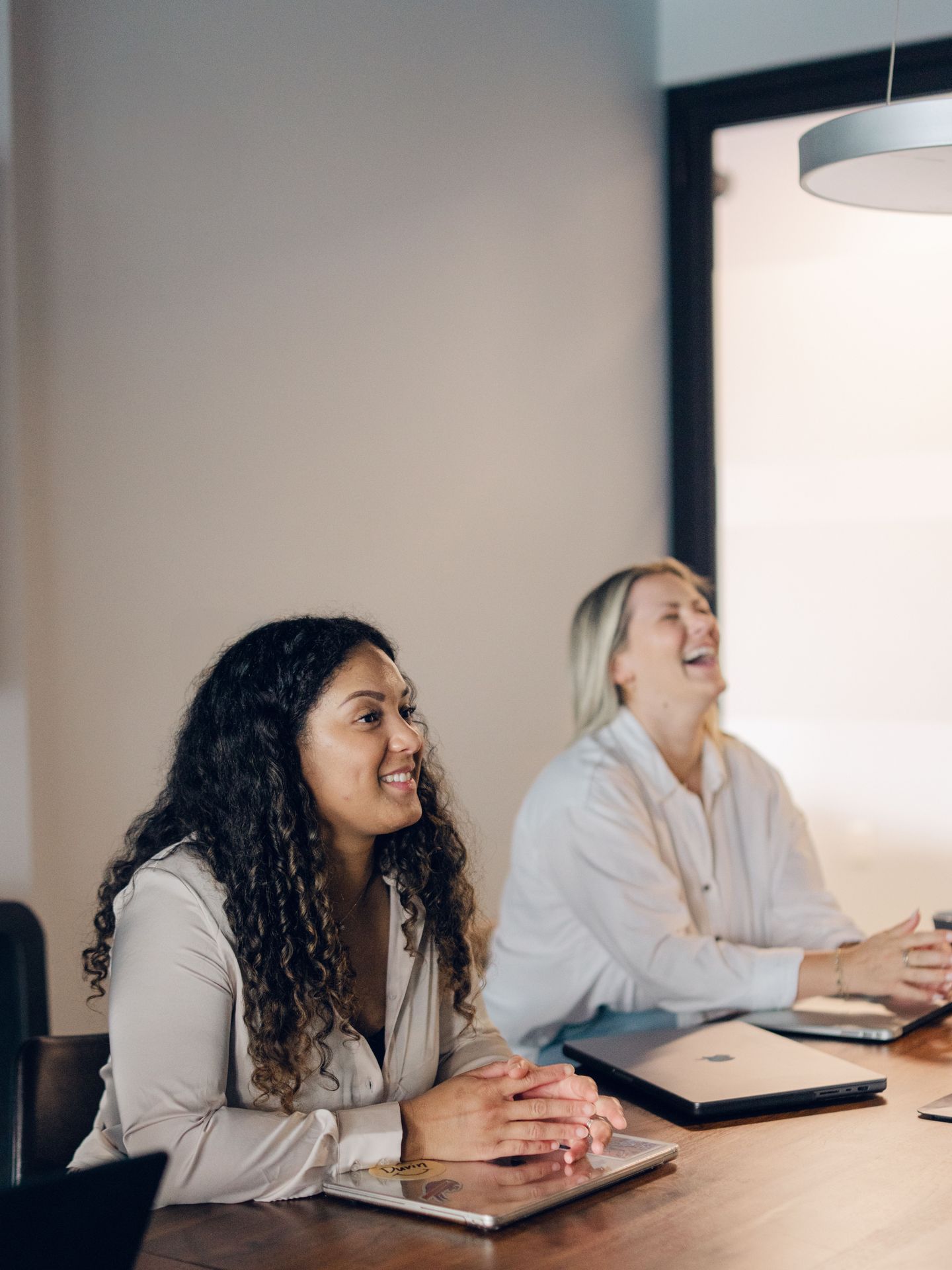 Jessie and Angel in a meeting at the office having fun
