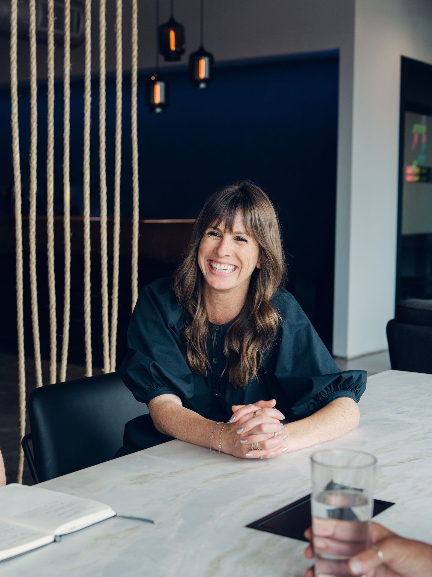 Sasha smiling in a meeting at the Robyn office